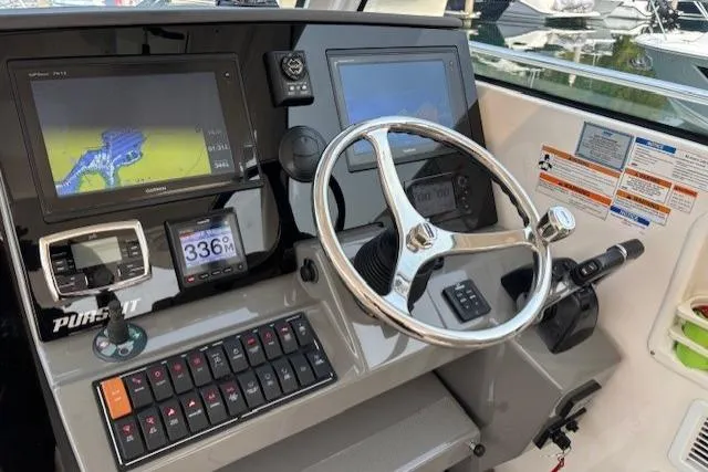 Syd Fishes Yacht Photos Pics 2017 Pursuit OS 325 Offshore boat dashboard with navigation screens and controls.