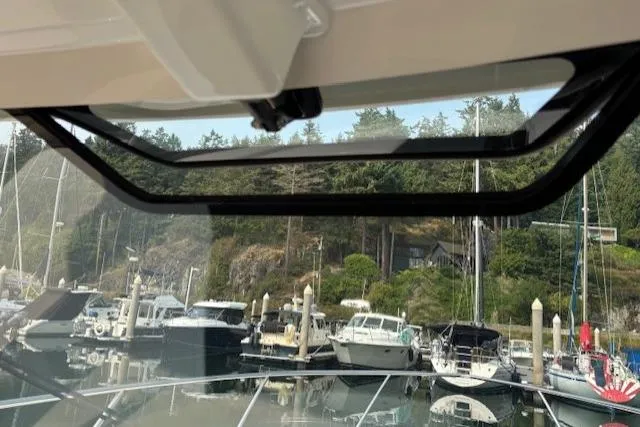 Syd Fishes Yacht Photos Pics 2017 Pursuit OS 325 Offshore boat view from cabin, overlooking marina with docked boats.