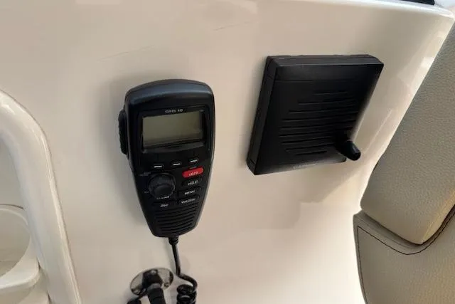 Syd Fishes Yacht Photos Pics VHF radio and speaker on 2017 Pursuit OS 325 Offshore boat dashboard.