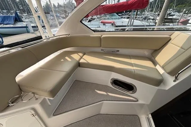 Syd Fishes Yacht Photos Pics 2017 Pursuit OS 325 Offshore boat interior with beige seating and marina view.