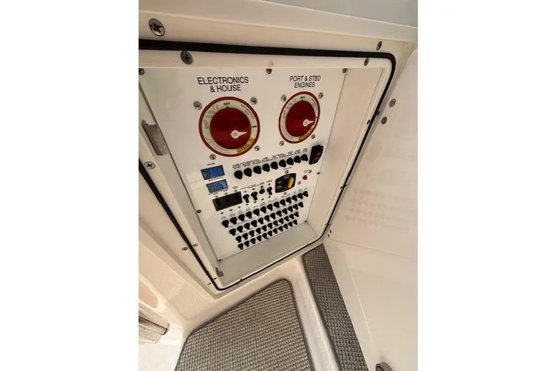 Syd Fishes Yacht Photos Pics Control panel of a 2017 Pursuit OS 325 Offshore boat, featuring electronics and engine switches.