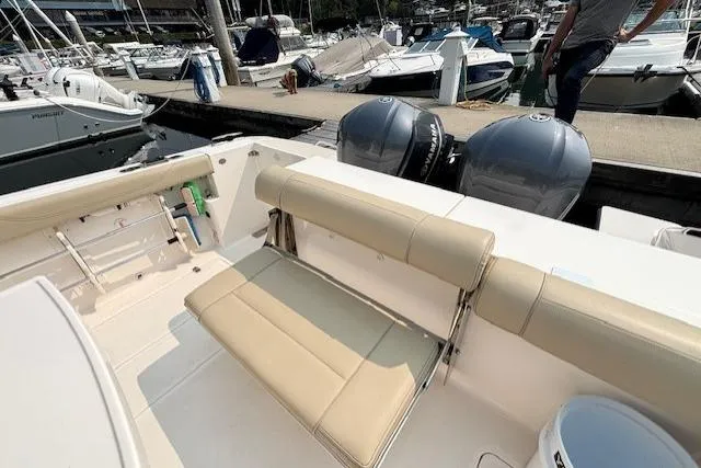Syd Fishes Yacht Photos Pics 2017 Pursuit OS 325 Offshore boat with dual engines and beige seating at a marina.