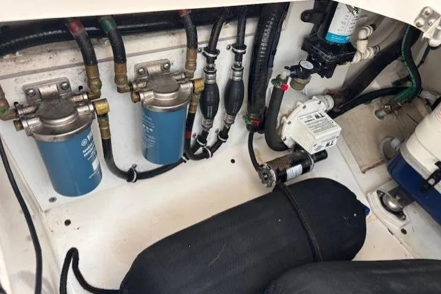 Syd Fishes Yacht Photos Pics Engine compartment of a 2017 Pursuit OS 325 Offshore boat, showing filters and hoses.