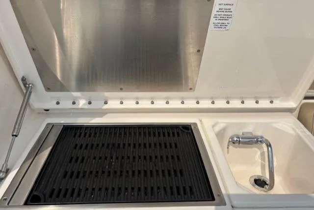 Syd Fishes Yacht Photos Pics Outdoor kitchen on a 2017 Pursuit OS 325 Offshore boat with grill and sink.