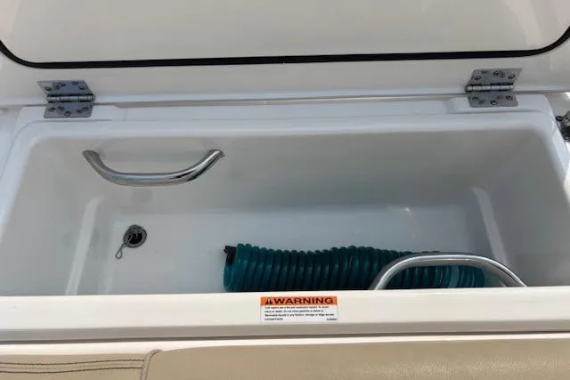 Syd Fishes Yacht Photos Pics Open storage compartment on 2017 Pursuit OS 325 Offshore boat with coiled hose inside.
