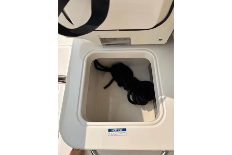Syd Fishes Yacht Photos Pics Open storage compartment on 2017 Pursuit OS 325 Offshore boat with coiled rope inside.