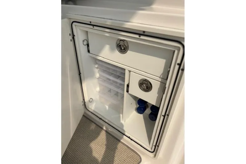 Syd Fishes Yacht Photos Pics Storage compartment on 2017 Pursuit OS 325 Offshore boat, featuring secure latches and organized interior.