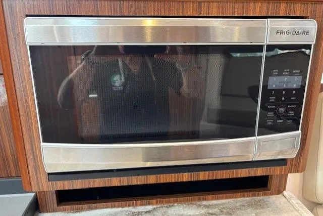 Syd Fishes Yacht Photos Pics Frigidaire microwave in 2017 Pursuit OS 325 Offshore boat kitchen.