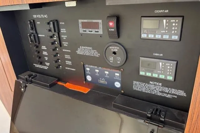 Syd Fishes Yacht Photos Pics Control panel of a 2017 Pursuit OS 325 Offshore boat, featuring various switches and displays.