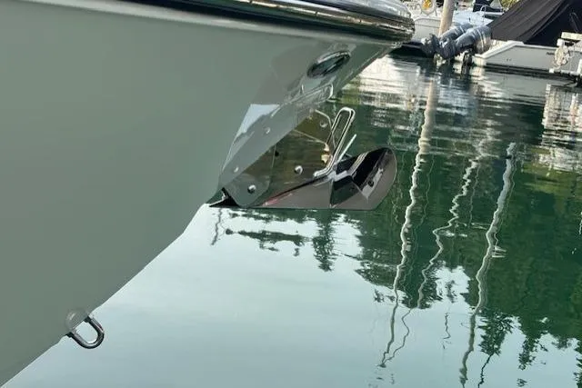 Syd Fishes Yacht Photos Pics 2017 Pursuit OS 325 Offshore boat bow with anchor, docked in calm water.