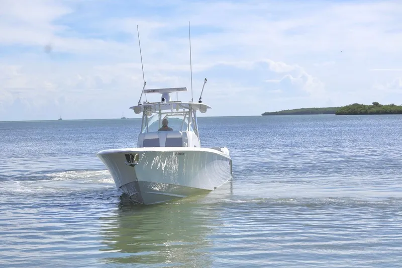 Yacht Photos Pics 2018 Contender 39 Fisharound boat cruising on calm waters under a clear sky.