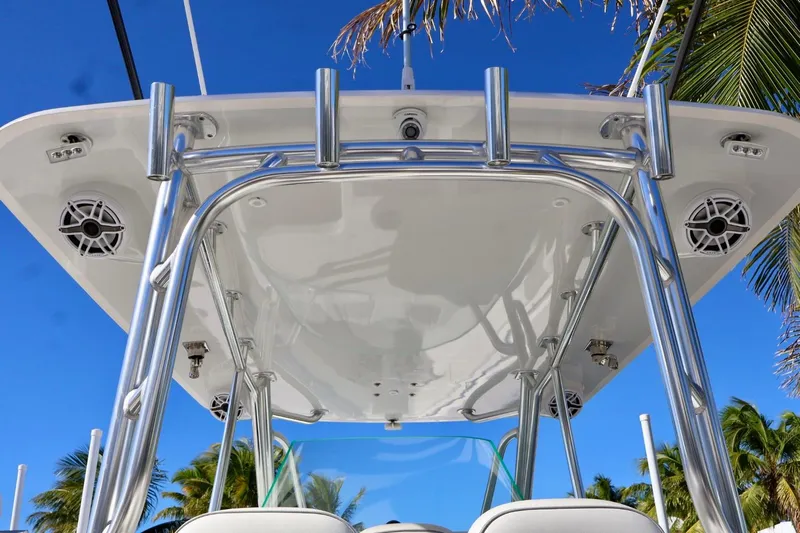  Yacht Photos Pics 2018 Contender 39 Fisharound boat with T-top and speakers, set against a tropical backdrop.