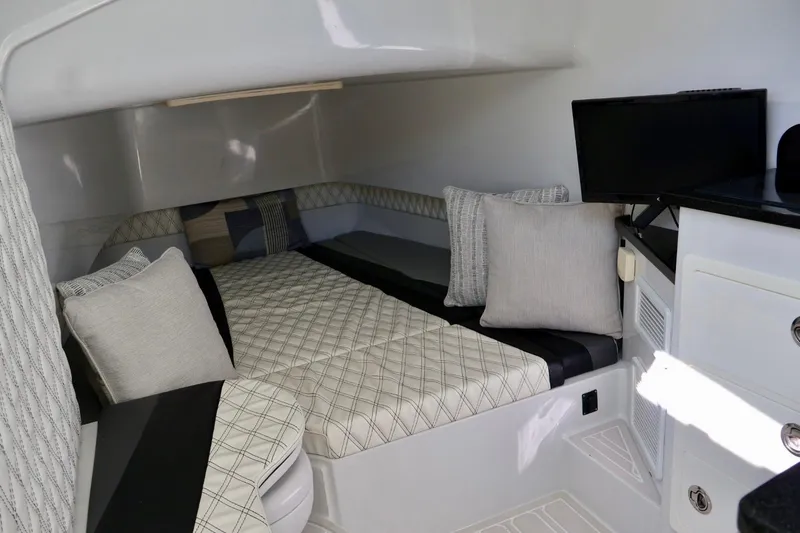  Yacht Photos Pics 2018 Contender 39 Fisharound cabin interior with bed, pillows, and TV.