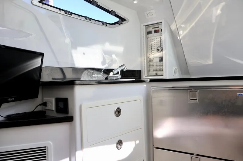  Yacht Photos Pics 2018 Contender 39 Fisharound interior with sink, control panel, and storage.