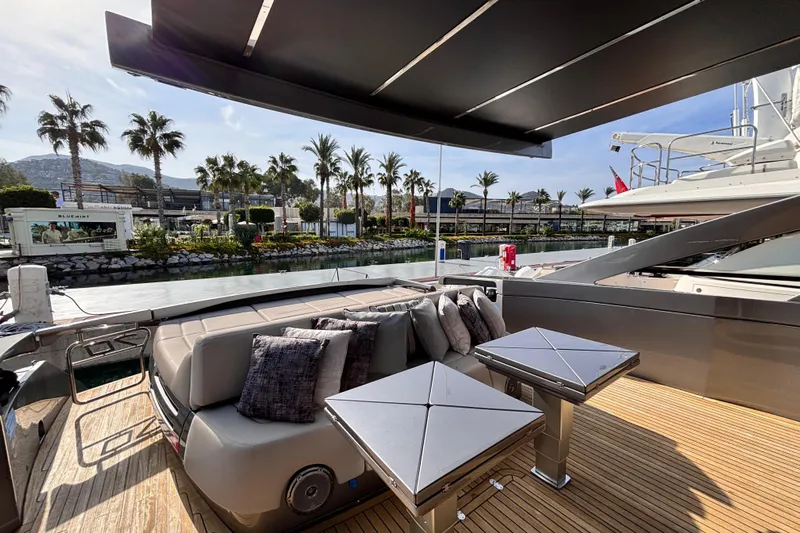  Yacht Photos Pics Luxurious 2019 Pershing 70 yacht deck with modern seating and scenic marina view.