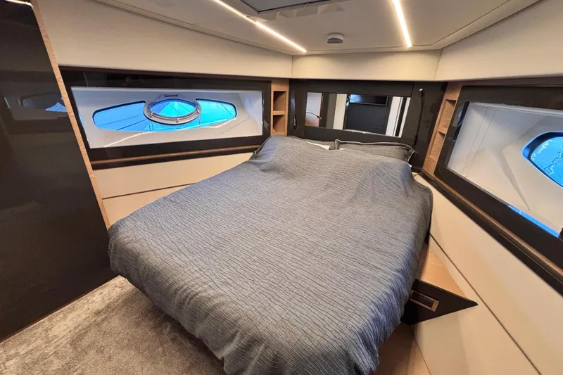  Yacht Photos Pics Luxurious bedroom interior of 2019 Pershing 70 yacht with modern design and large windows.