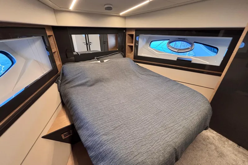  Yacht Photos Pics Luxurious bedroom interior of 2019 Pershing 70 yacht with modern design and large windows.