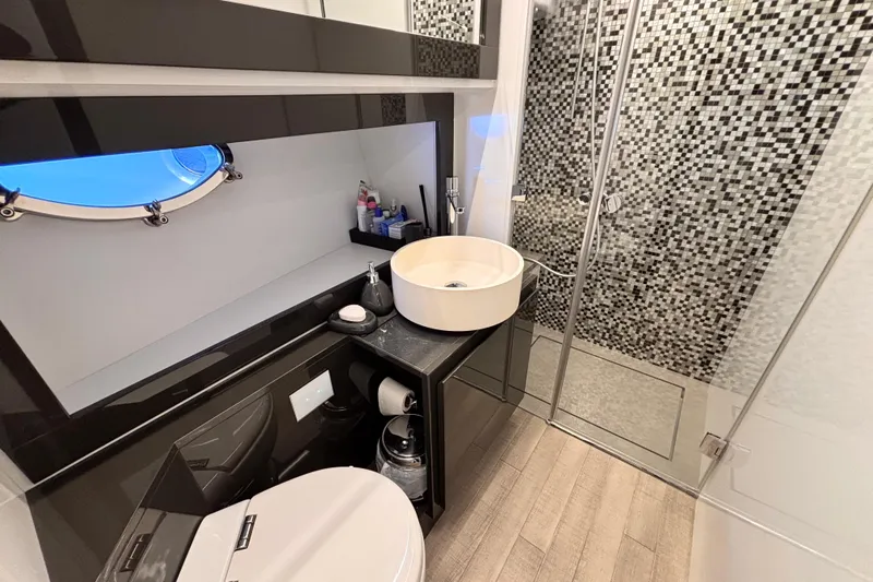 Yacht Photos Pics Luxurious bathroom in 2019 Pershing 70 yacht with modern fixtures and mosaic shower tiles.
