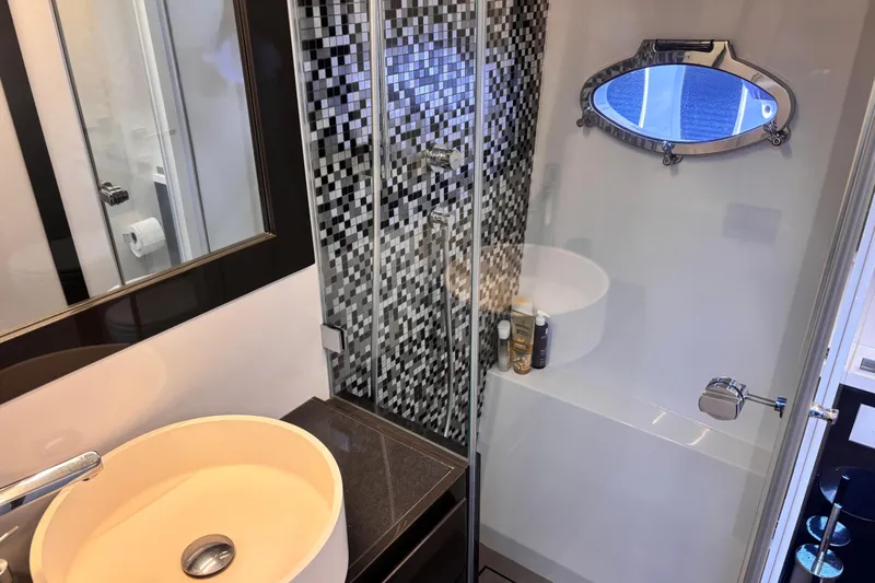  Yacht Photos Pics Luxurious bathroom in 2019 Pershing 70 yacht with modern fixtures and mosaic tiles.
