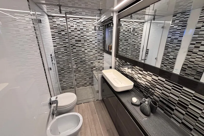  Yacht Photos Pics Luxurious bathroom in 2019 Pershing 70 yacht with modern fixtures and stylish tile design.