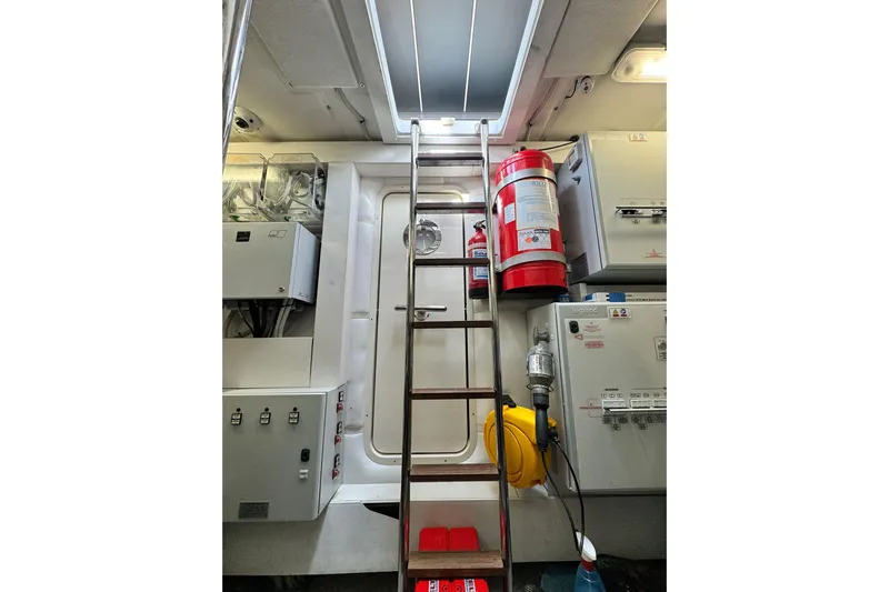  Yacht Photos Pics Engine room of 2019 Pershing 70 yacht with ladder and safety equipment.