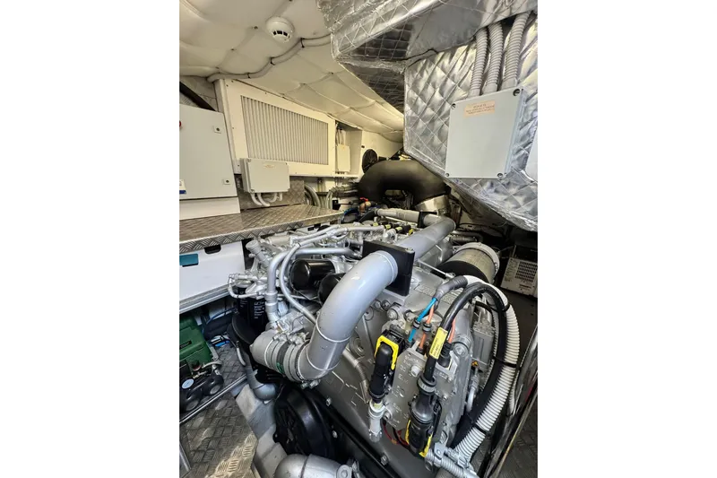  Yacht Photos Pics Engine room of 2019 Pershing 70 yacht, showcasing complex machinery and piping.