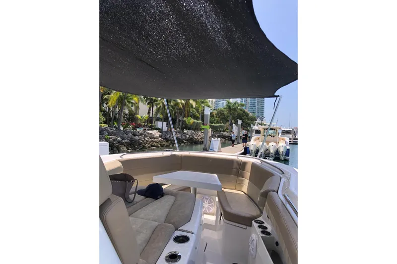  Yacht Photos Pics 2019 Sailfish 360 CC boat interior with seating and canopy at marina.