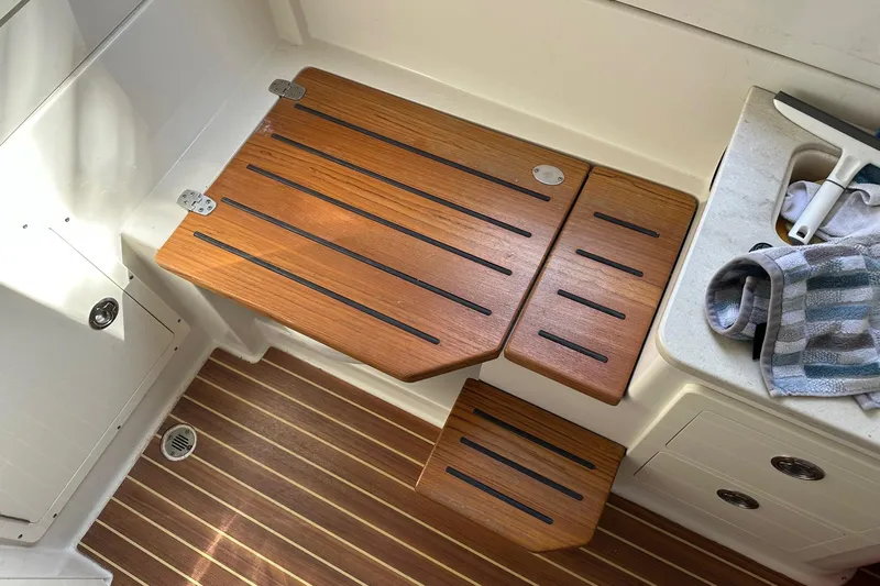  Yacht Photos Pics 2019 Sailfish 360 CC boat interior with wooden steps and striped towel.