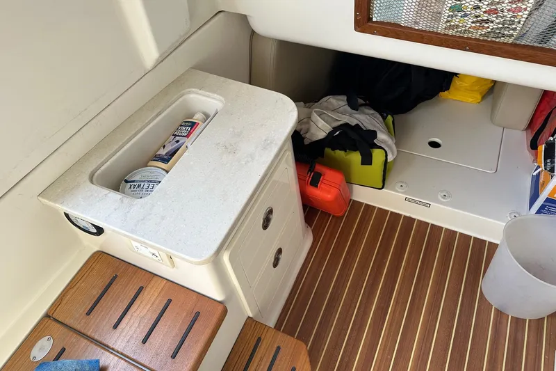  Yacht Photos Pics Interior of 2019 Sailfish 360 CC boat with storage and wooden flooring.