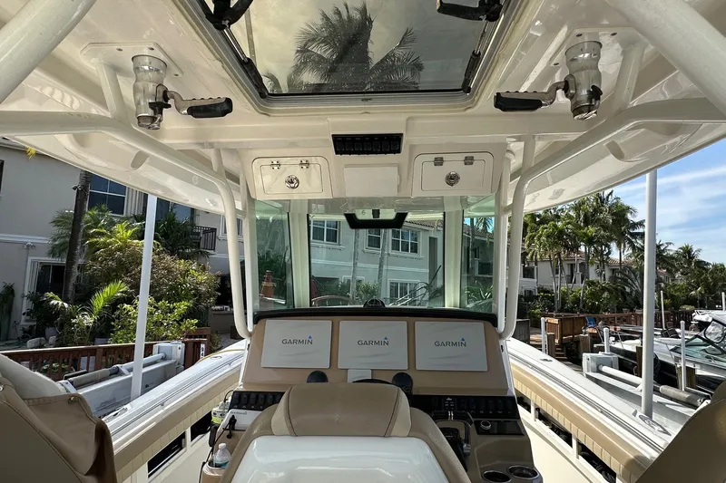 Yacht Photos Pics 2019 Sailfish 360 CC boat cockpit with Garmin displays and overhead storage.