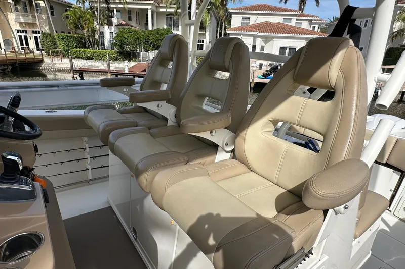  Yacht Photos Pics Luxurious seating on 2019 Sailfish 360 CC boat, featuring beige leather chairs and armrests.