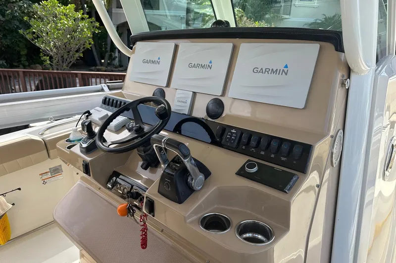  Yacht Photos Pics 2019 Sailfish 360 CC boat dashboard with Garmin navigation displays and steering wheel.