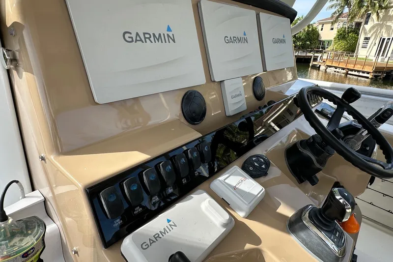  Yacht Photos Pics 2019 Sailfish 360 CC boat dashboard with Garmin navigation systems and steering wheel.