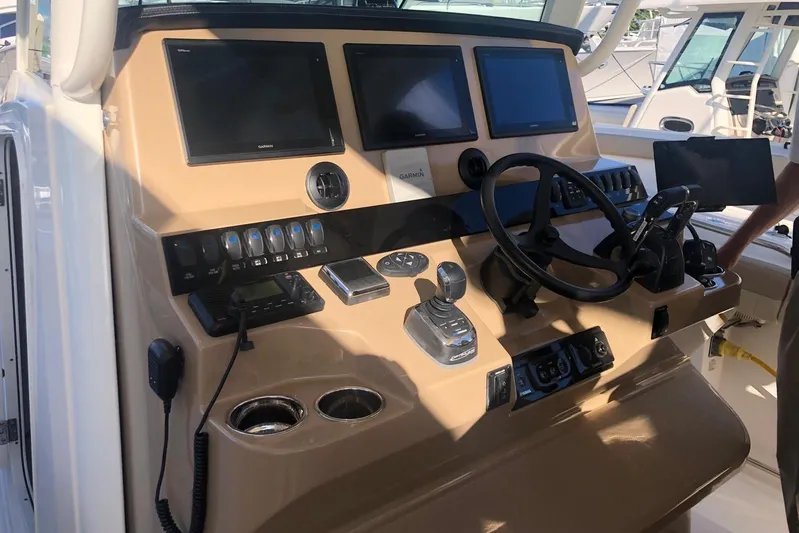  Yacht Photos Pics Control panel of 2019 Sailfish 360 CC boat with steering wheel and navigation screens.