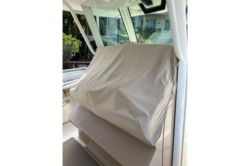  Yacht Photos Pics Covered console area of a 2019 Sailfish 360 CC boat, showcasing protective cover.
