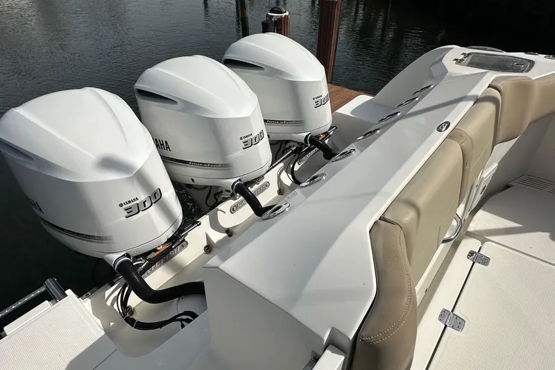  Yacht Photos Pics 2019 Sailfish 360 CC boat with triple Yamaha 300 engines, docked by the water.