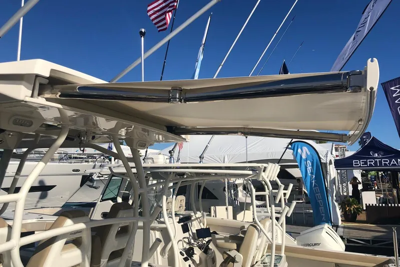  Yacht Photos Pics 2019 Sailfish 360 CC boat with retractable canopy at a boat show.