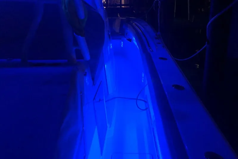  Yacht Photos Pics 2019 Sailfish 360 CC boat illuminated with blue LED lights at night.