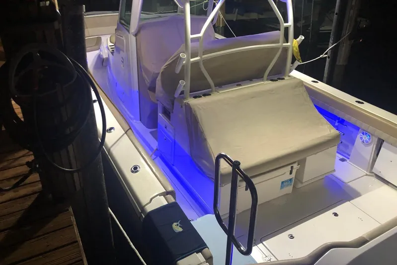 Yacht Photos Pics 2019 Sailfish 360 CC boat with illuminated deck and covered seating at night.
