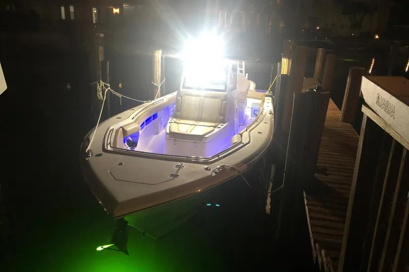  Yacht Photos Pics 2019 Sailfish 360 CC boat docked at night with bright lights and green underwater glow.
