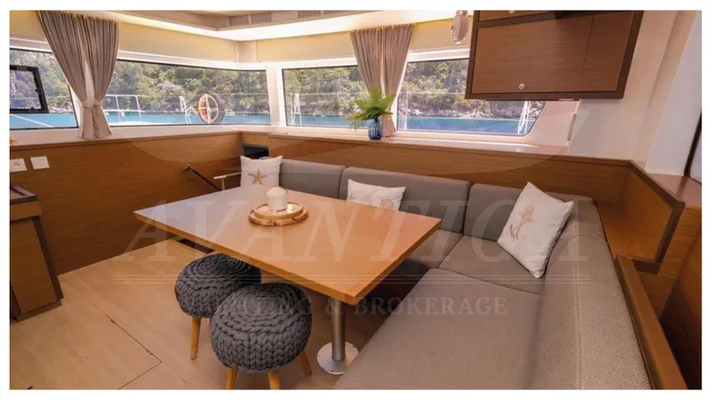 Yacht Photos Pics Luxurious interior of 2020 Lagoon 52 F yacht with elegant seating and panoramic windows.