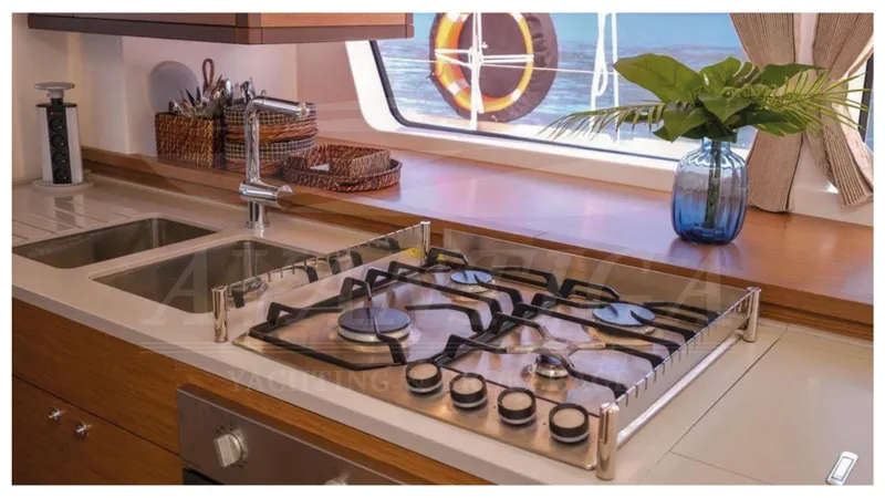  Yacht Photos Pics Modern kitchen in 2020 Lagoon 52 F yacht with stove, sink, and ocean view.