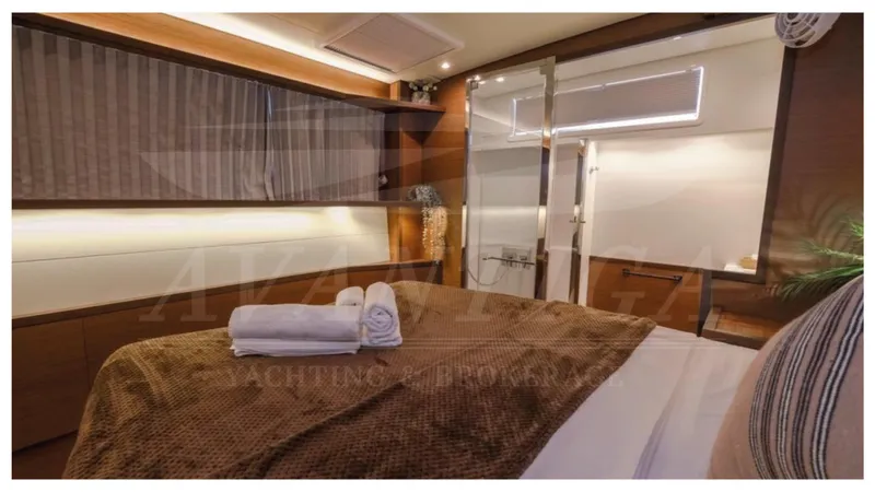  Yacht Photos Pics Luxurious cabin interior of 2020 Lagoon 52 F yacht with cozy bedding and modern design.