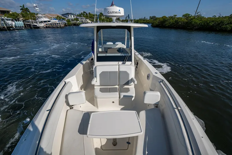  Yacht Photos Pics 2021 Pursuit S 288 Sport boat cruising on a scenic waterway.