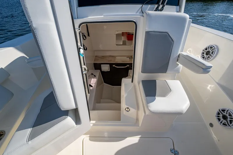  Yacht Photos Pics 2021 Pursuit S 288 Sport boat interior with seating and storage area.