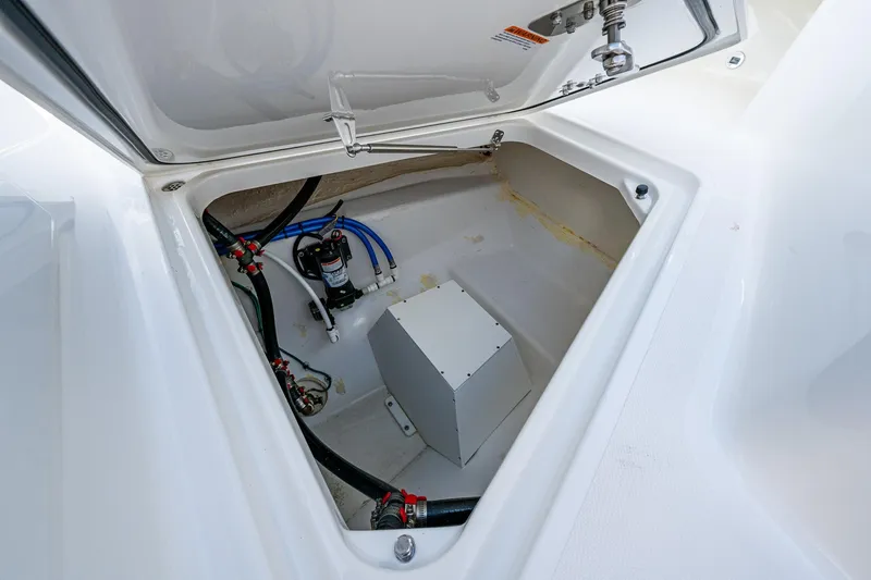  Yacht Photos Pics 2021 Pursuit S 288 Sport boat storage compartment with wiring and pump system.