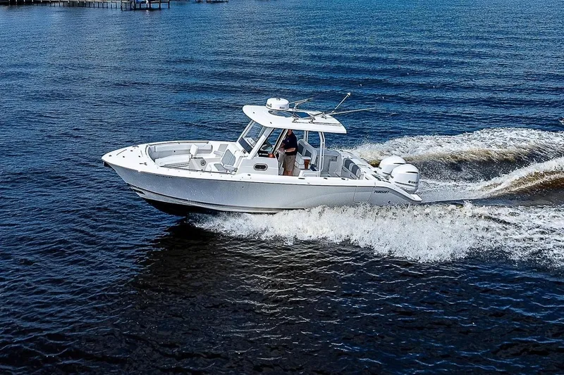  Yacht Photos Pics 2021 Pursuit S 288 Sport boat cruising on open water, creating waves.