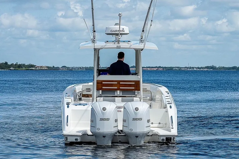  Yacht Photos Pics 2021 Pursuit S 288 Sport boat on calm water, rear view with dual engines.