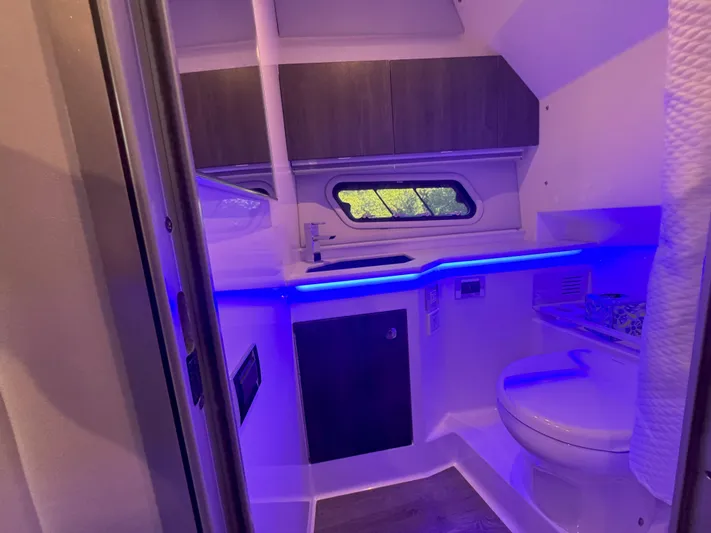 Aseage Yacht Photos Pics Interior of 2022 Formula 380 Super Sport Crossover OB boat bathroom with blue lighting.
