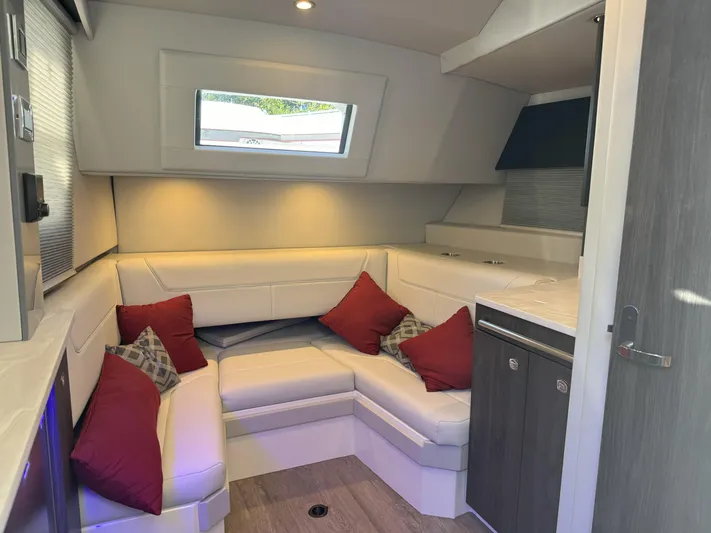 Aseage Yacht Photos Pics 2022 Formula 380 Super Sport Crossover OB interior with white seating and red cushions.